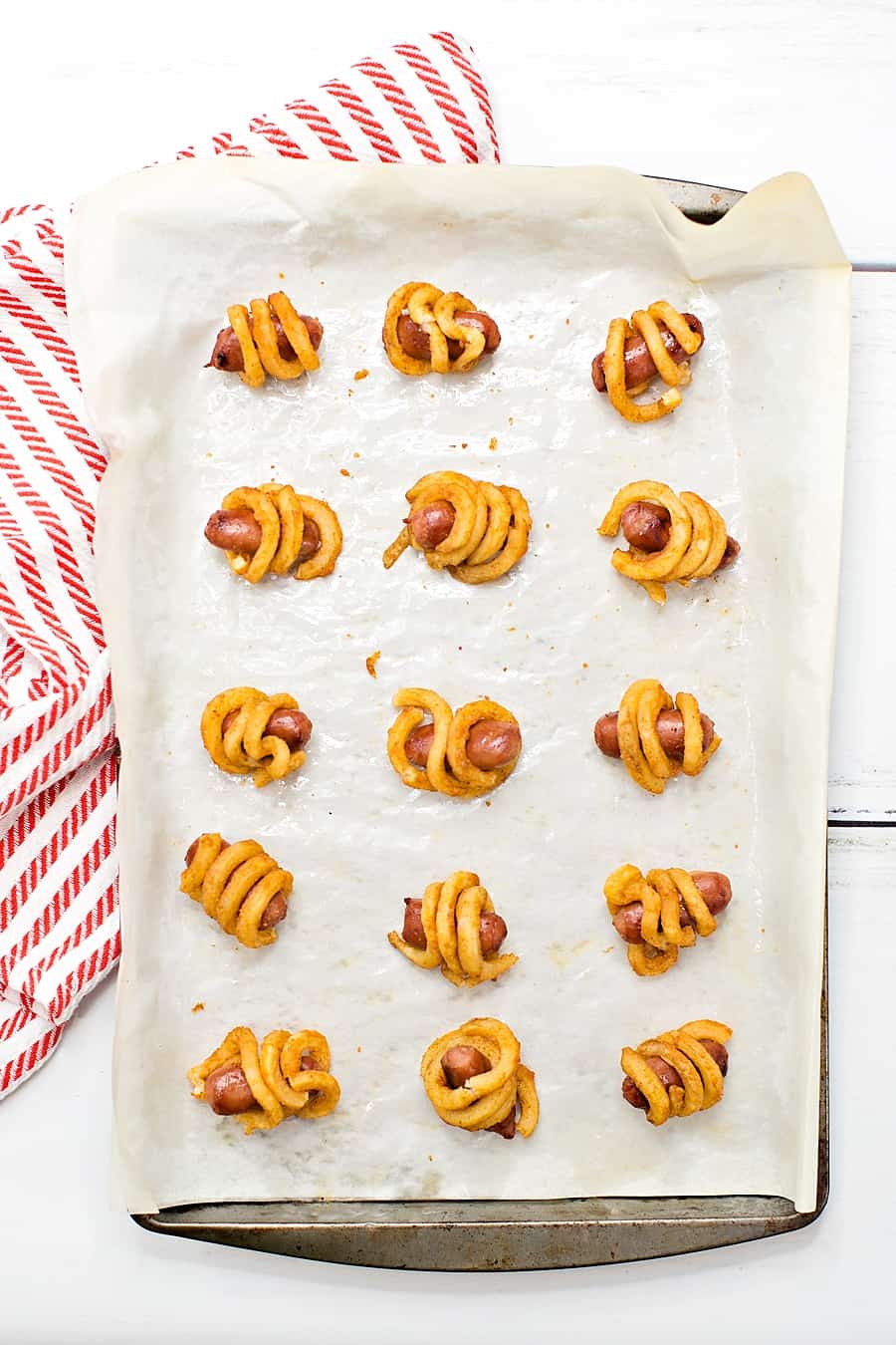 Combine two favorite iconic foods into one yummy bite-sized lunch or dinner for kids with these curly fries mini hot dogs. 