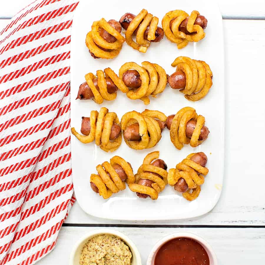 Combine two favorite iconic foods into one yummy bite-sized lunch or dinner for kids with these curly fries mini hot dogs. 