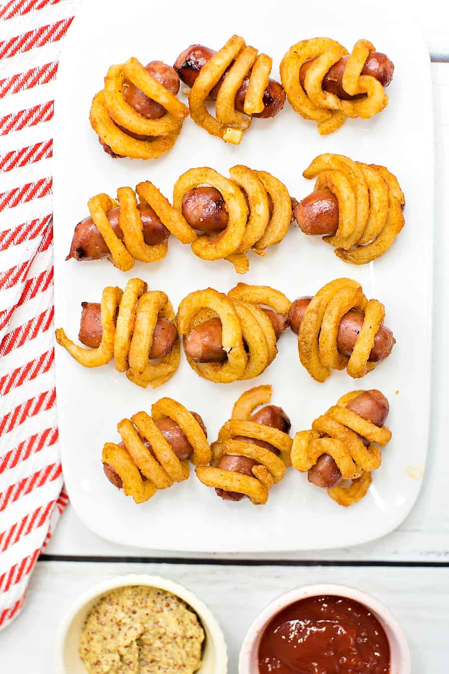 Combine two favorite iconic foods into one yummy bite-sized lunch or dinner for kids with these curly fries mini hot dogs. 