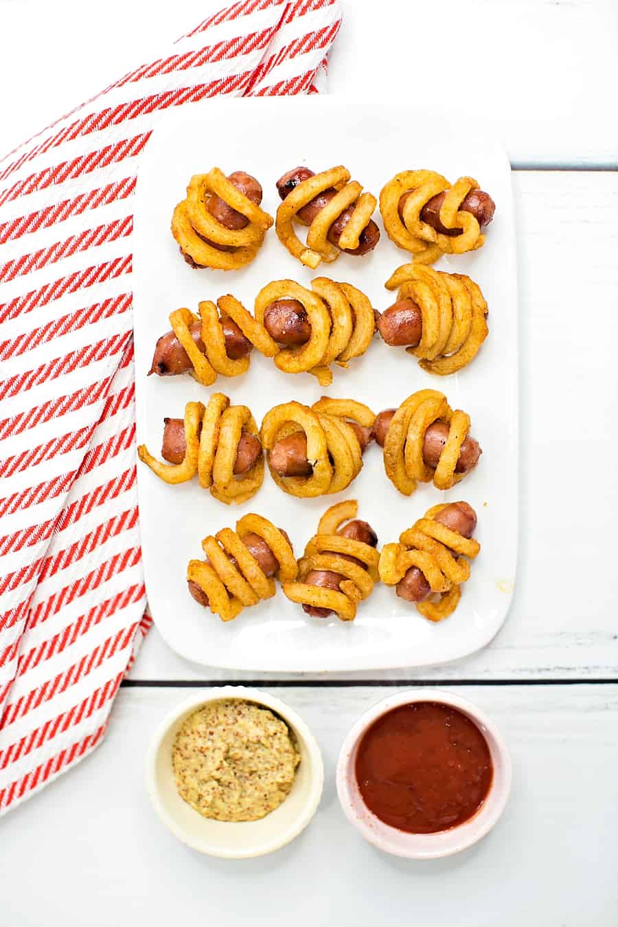 Combine two favorite iconic foods into one yummy bite-sized lunch or dinner for kids with these curly fries mini hot dogs. 
