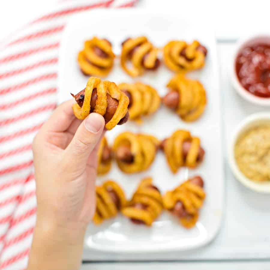 Combine two favorite iconic foods into one yummy bite-sized lunch or dinner for kids with these curly fries mini hot dogs. 