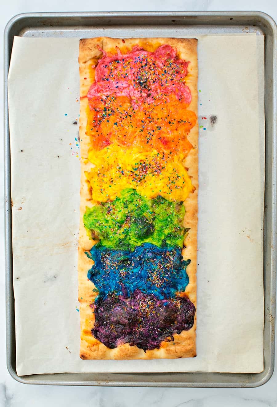 Our Rainbow Glitter Unicorn Pizza is the (easiest!) most magical pizza you'll ever eat. This stunning snack will be the healthy hightight of your party!