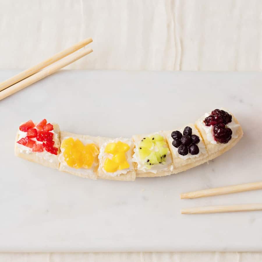 Kids will love getting a healthy, vitamin-packed start to their day with this rainbow fruit banana sushi - a fun snack featuring fresh fruit!