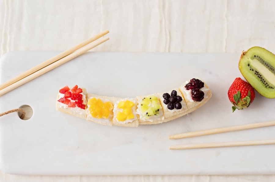 Kids will love getting a healthy, vitamin-packed start to their day with this rainbow fruit banana sushi - a fun snack featuring fresh fruit!