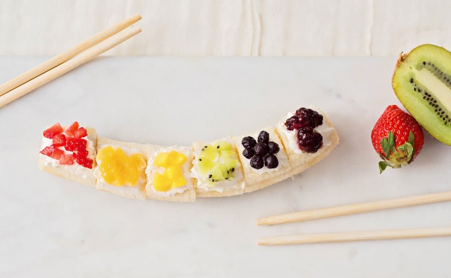 Kids will love getting a healthy, vitamin-packed start to their day with this rainbow fruit banana sushi - a fun snack featuring fresh fruit!