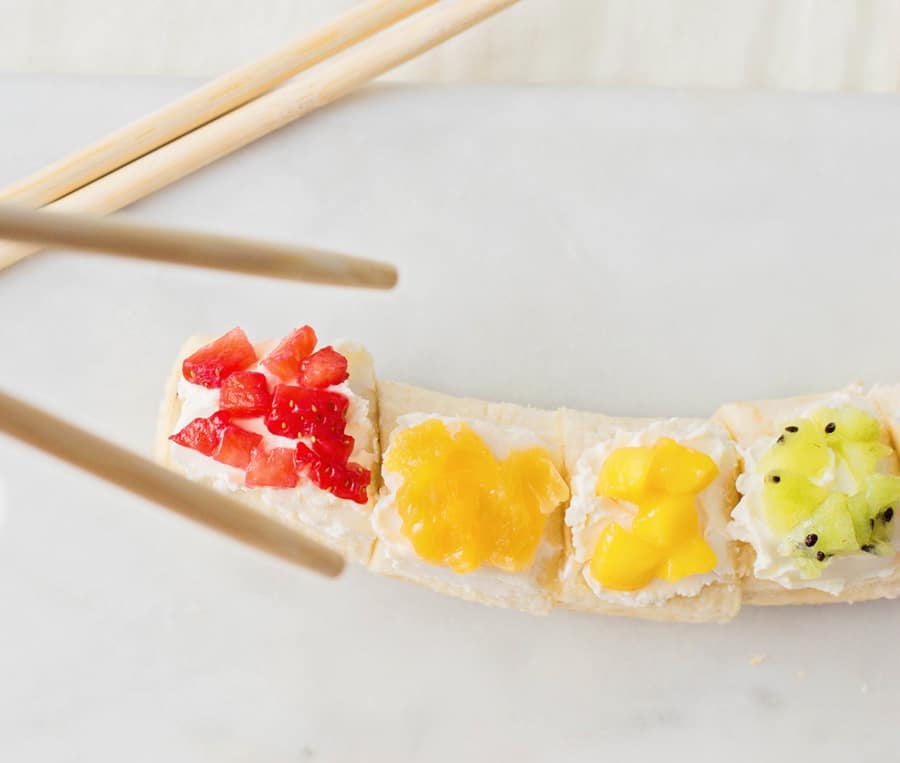 Kids will love getting a healthy, vitamin-packed start to their day with this rainbow fruit banana sushi - a fun snack featuring fresh fruit!