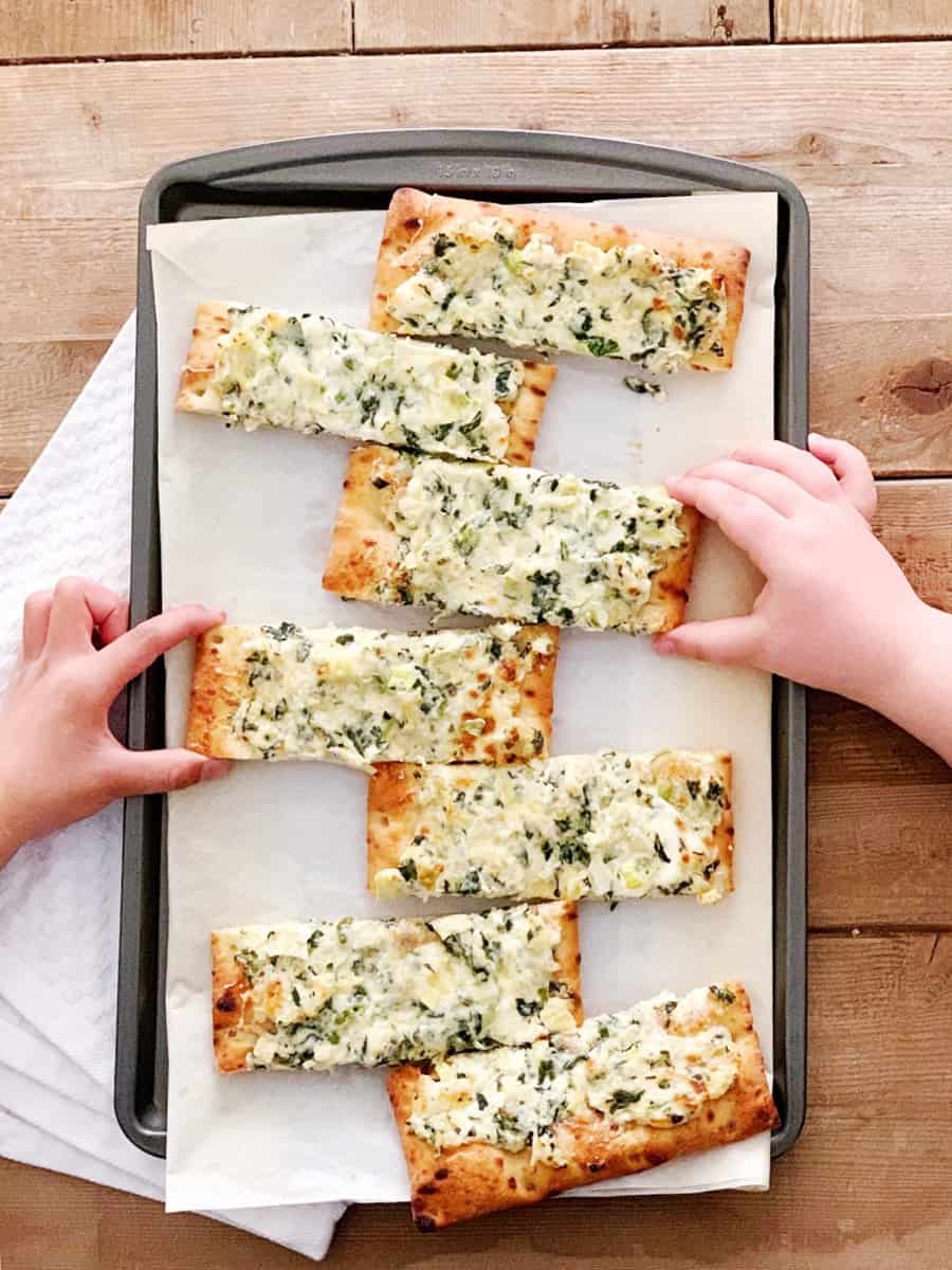 Turn your favorite dip into Spinach Artichoke Dip Pizza for a yummy dinner kids and adults will love! Pre-made crust makes this an easy weeknight meal!