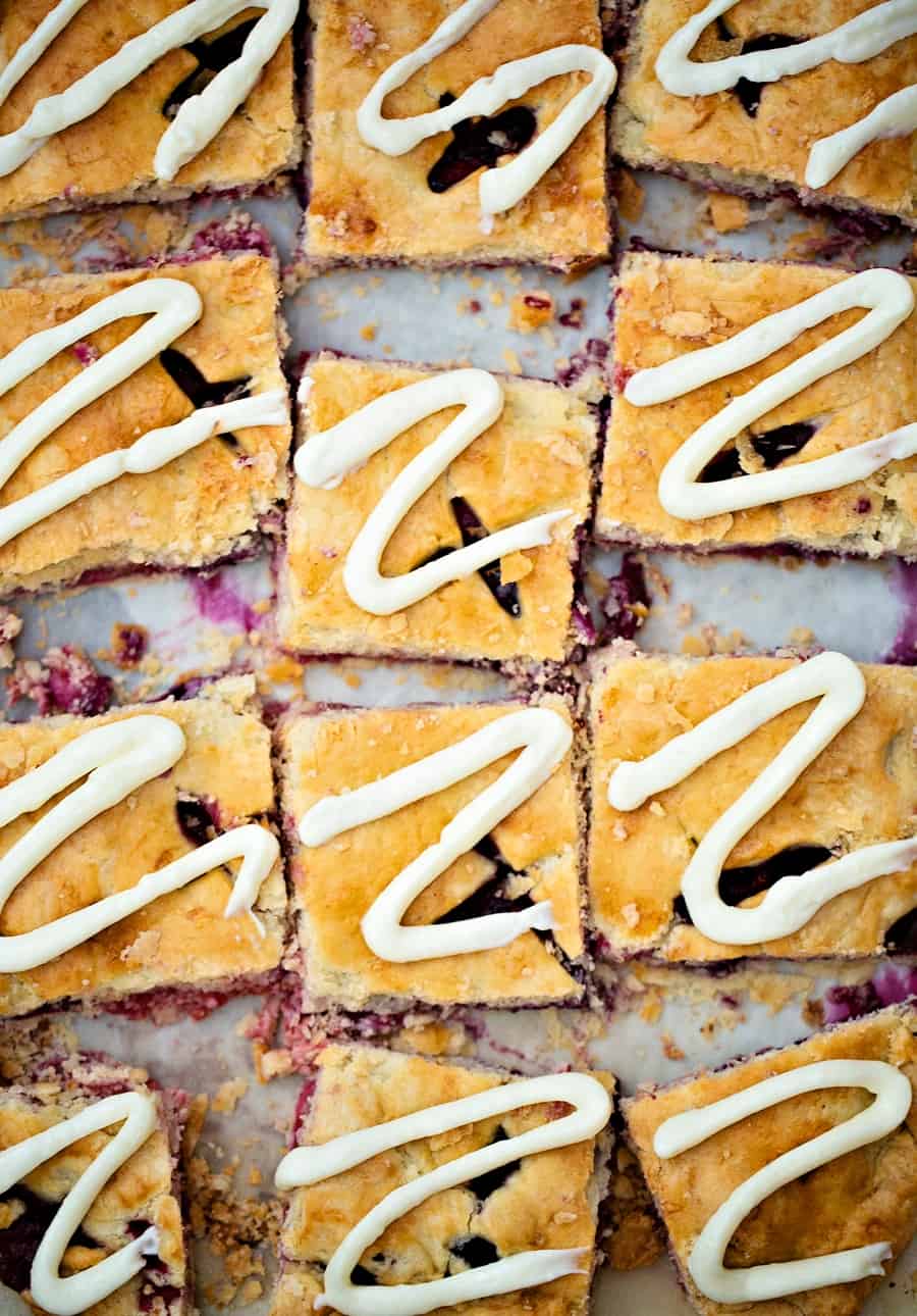 Raspberry Blueberry Slab Pie with cream cheese frosting drizzle. Delicious and easy patriotic dessert for Memorial Day or Fourth of July. 