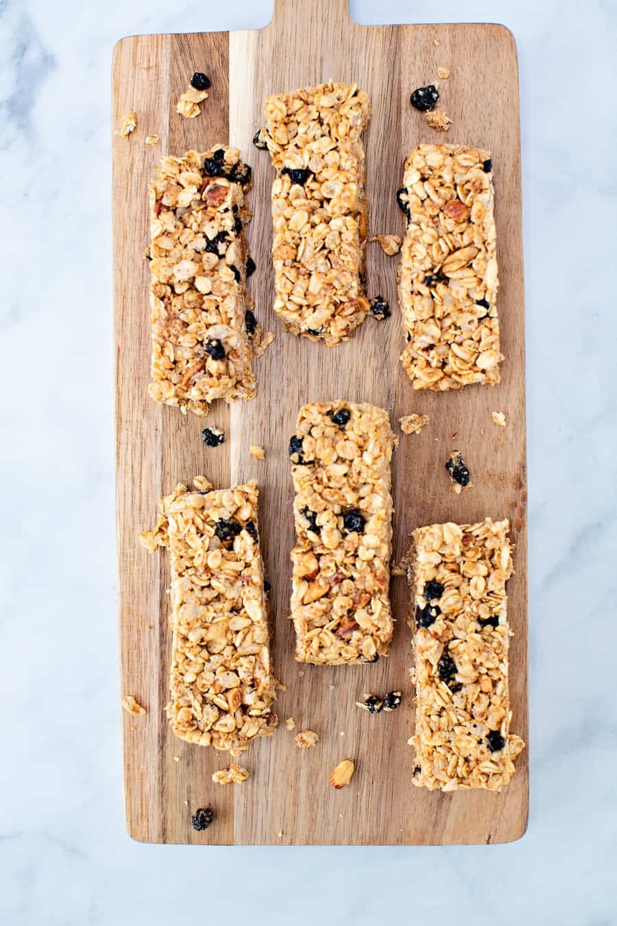 No Bake Blueberry Almond Granola Bars on a wooden cutting board