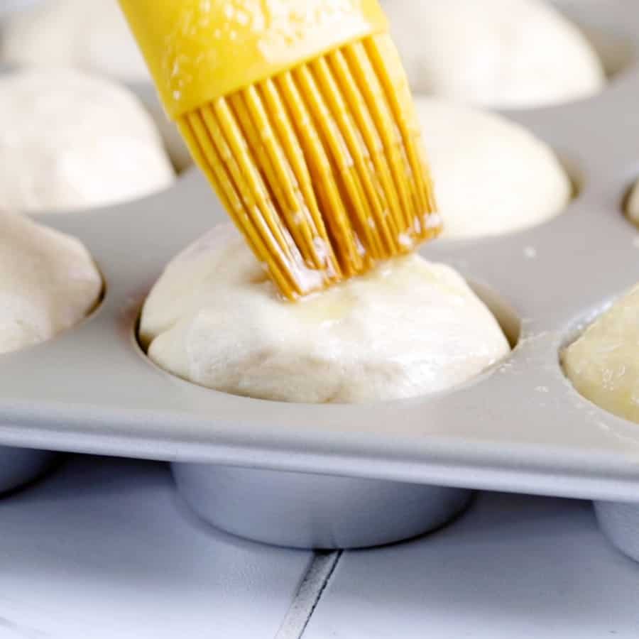 Ham and Broccoli Cheddar Cheese Bombs - brushing tops with buttter