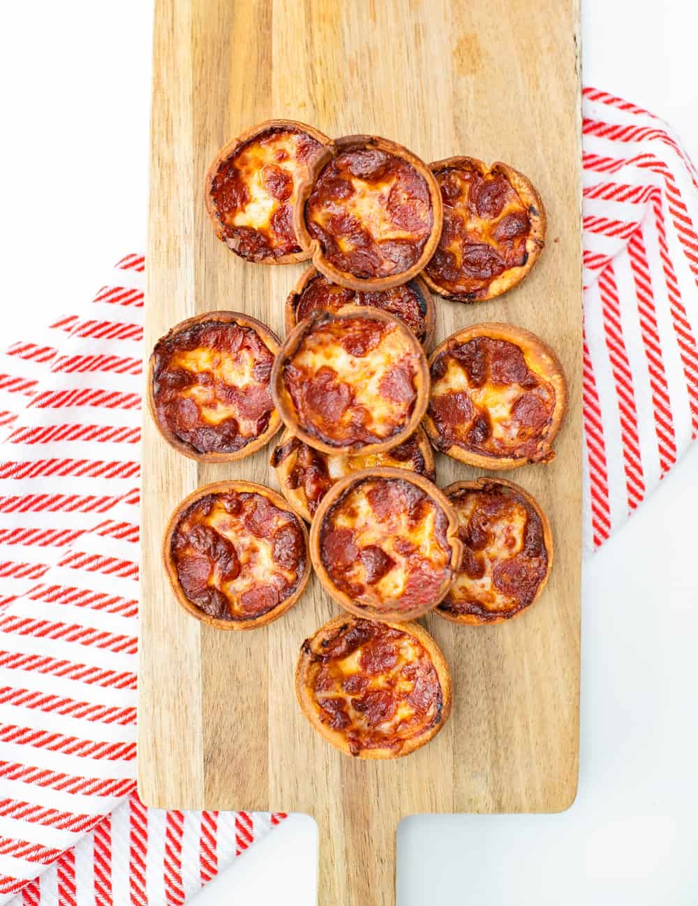 muffin tin pizza on a wooden board