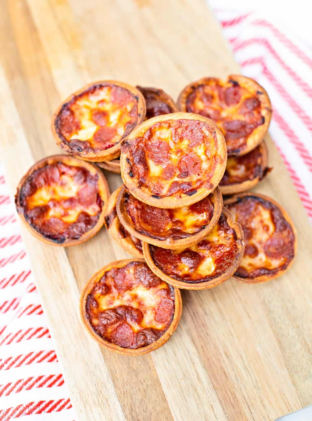 Muffin tin pizza on a wooden board