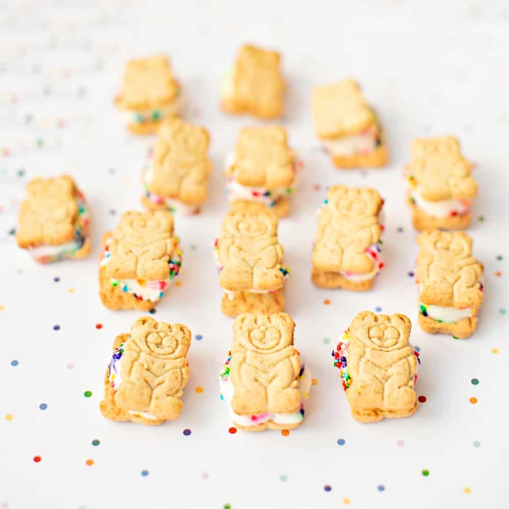 mini teddy bear graham ice cream sandwiches lying over rainbow dot paper