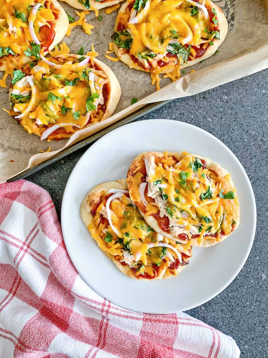 2 pieces of BBQ Chicken Naan Pizzas on a white plate 