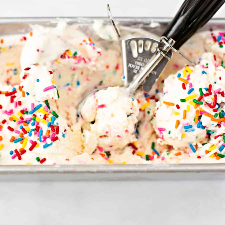 ice cream scoop inside a pan of homemade ice cream