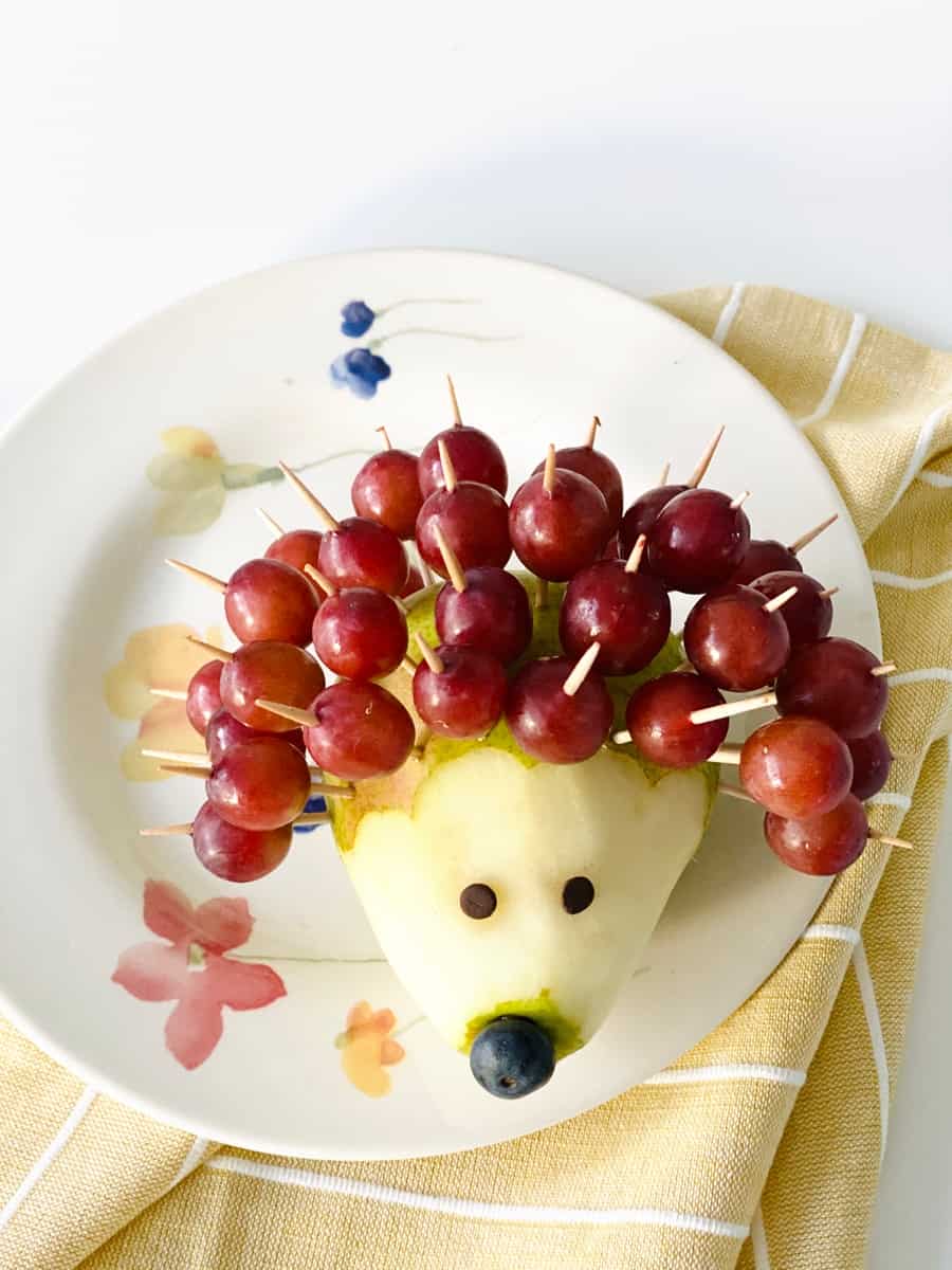 pear hedgehog made of grapes as quills