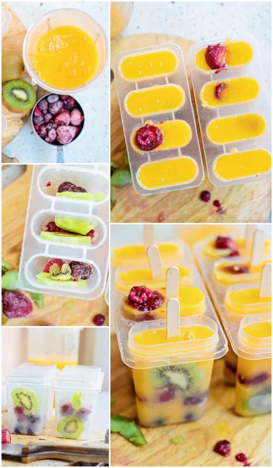 mango popsicles inside a popsicle mold with frozen kiwi and berries