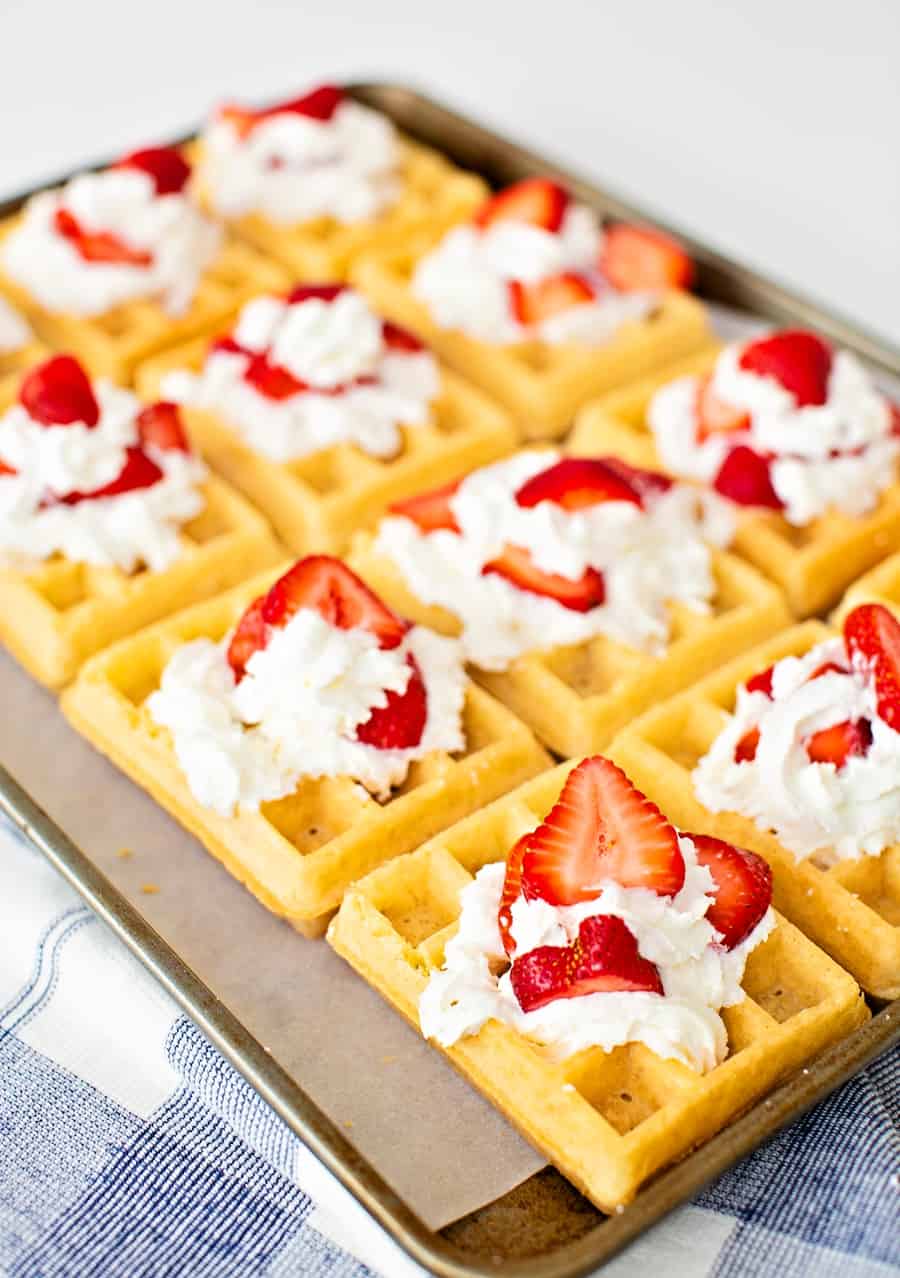 sheet pan waffles with whipped cream and strawberries