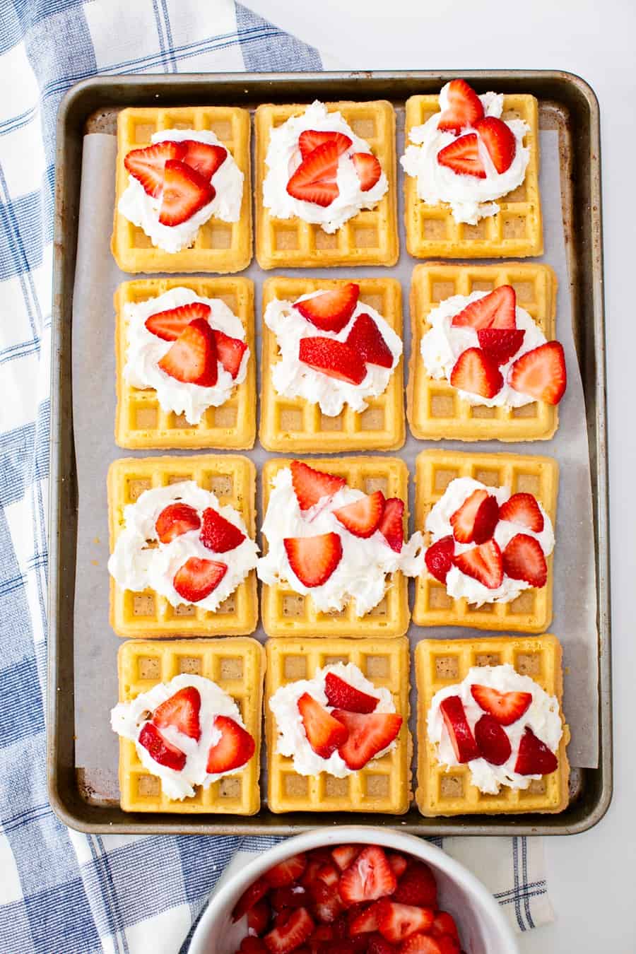 sheet pan waffles with whipped cream and strawberries