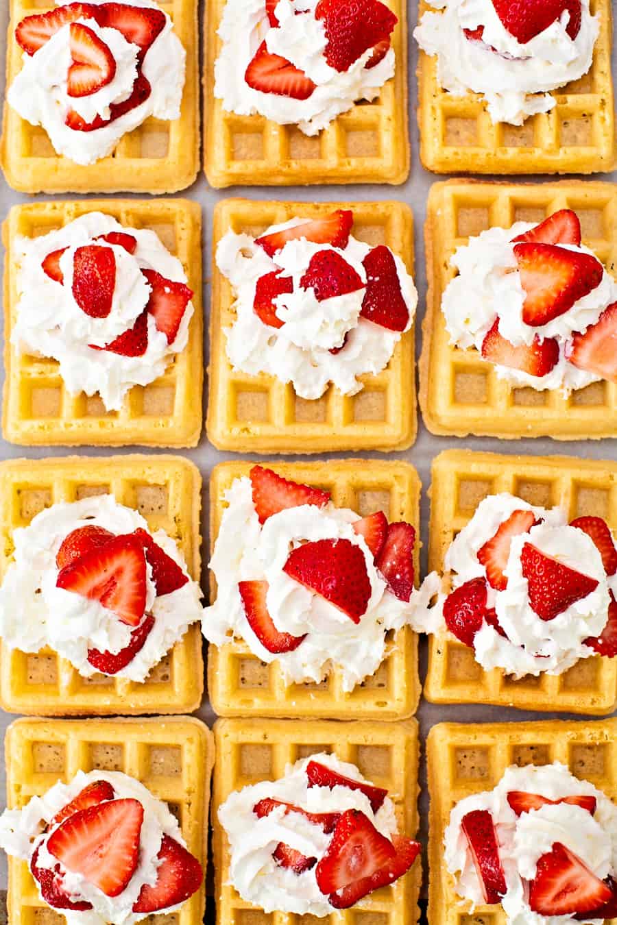 sheet pan waffles with whipped cream and strawberries