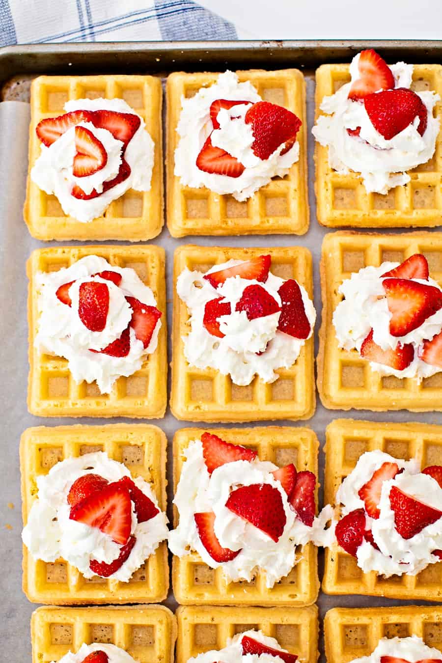 sheet pan waffles with whipped cream and strawberries