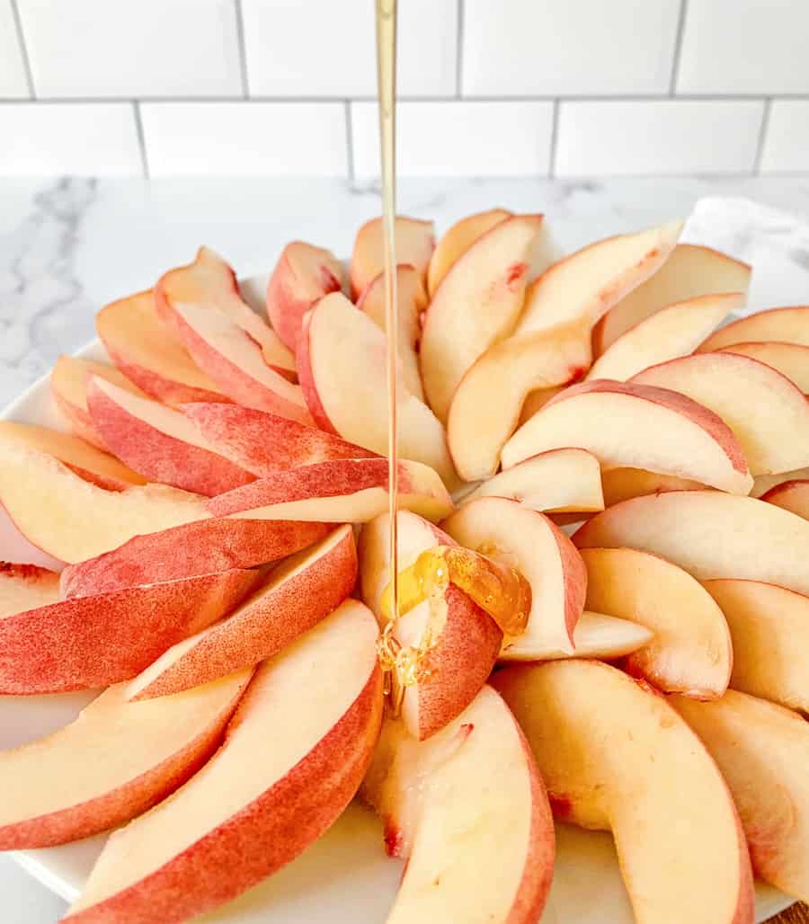 honey drizzled over sliced peaches