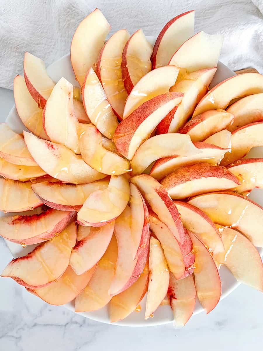 sliced peaches in a spiral to make fruit nachos