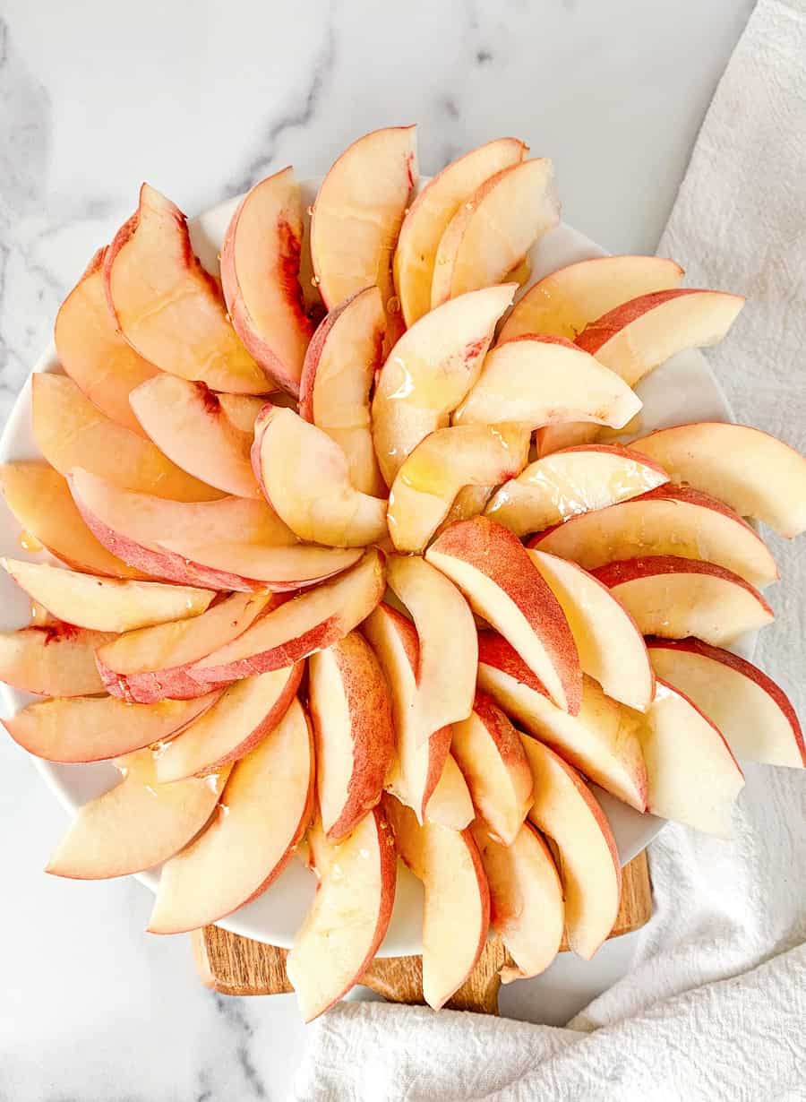 sliced peaches in a spiral to make fruit nachos