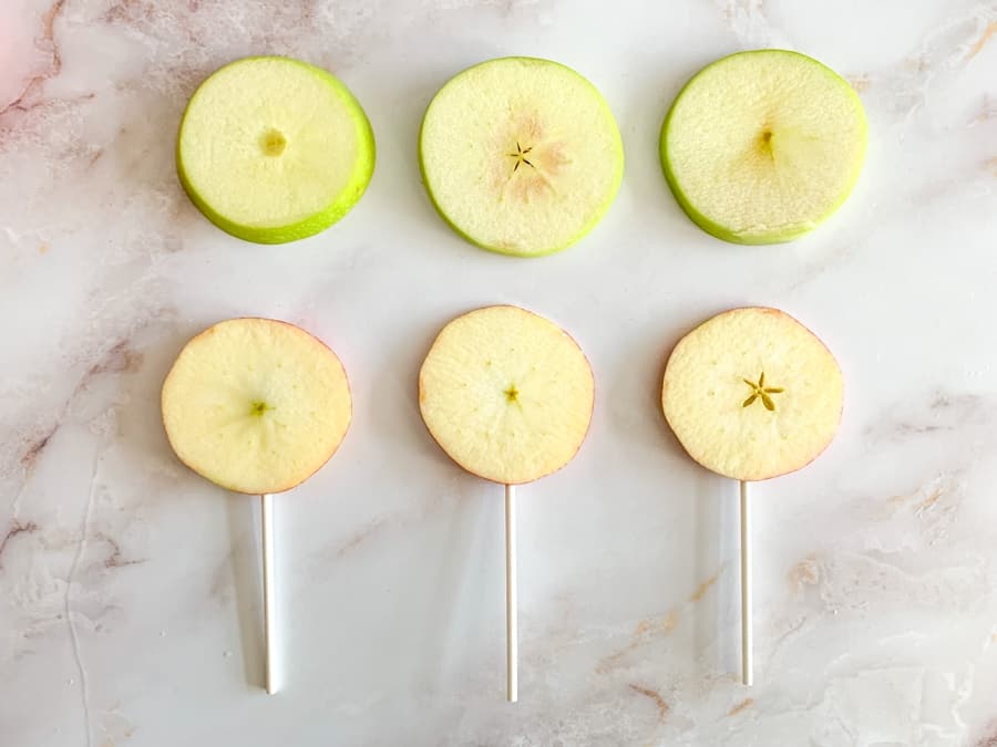 sliced apples into lollipop sticks