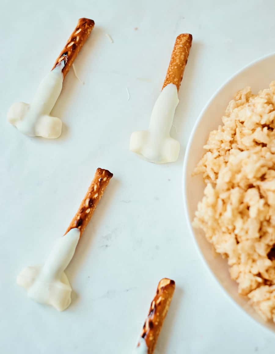 dipping chocolate onto pretzels 