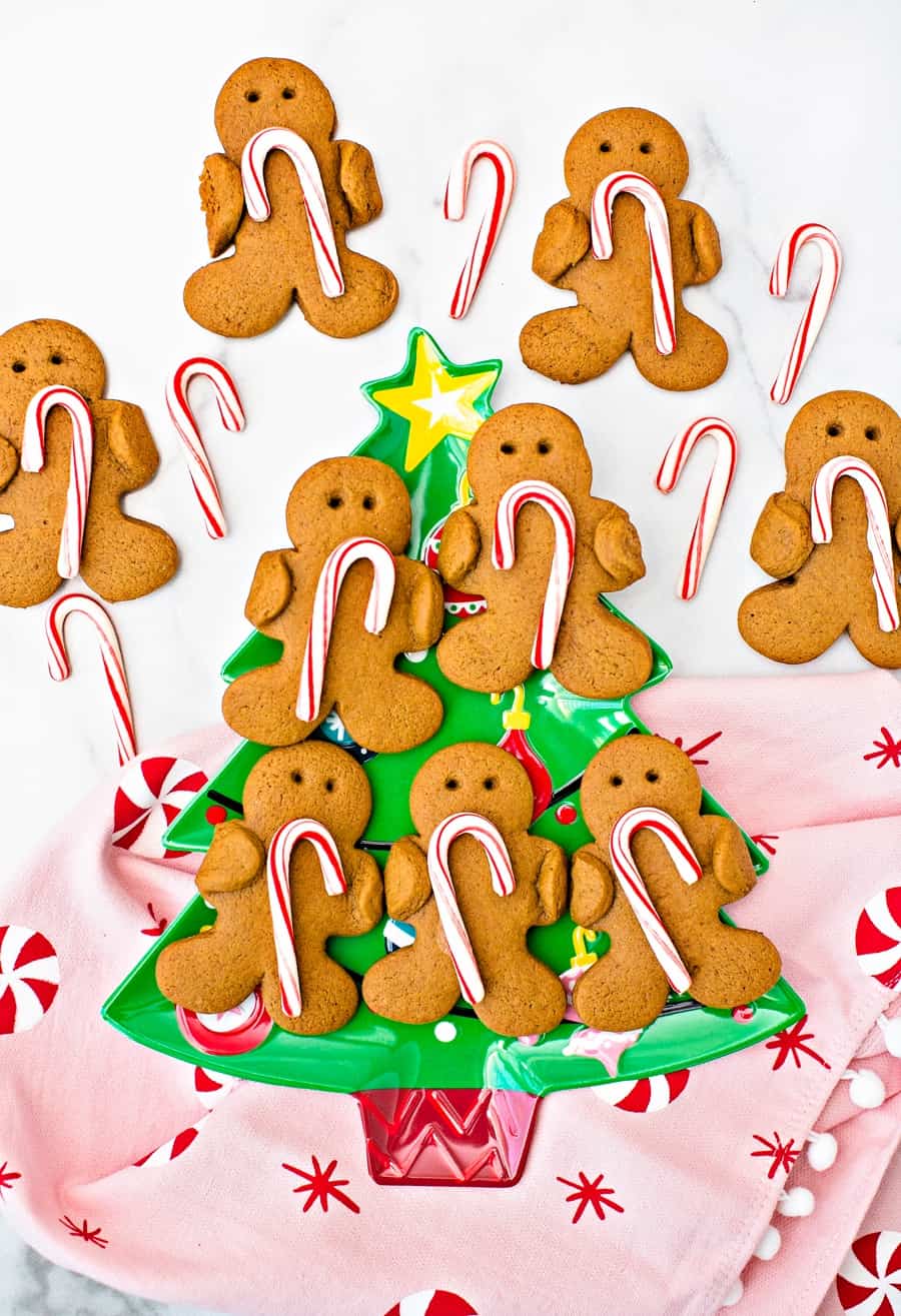 Gingerbread men cookies holding candy canes