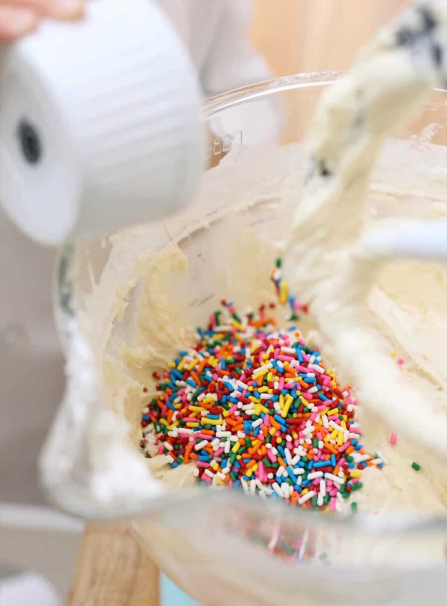 kids baking sprinkles cake