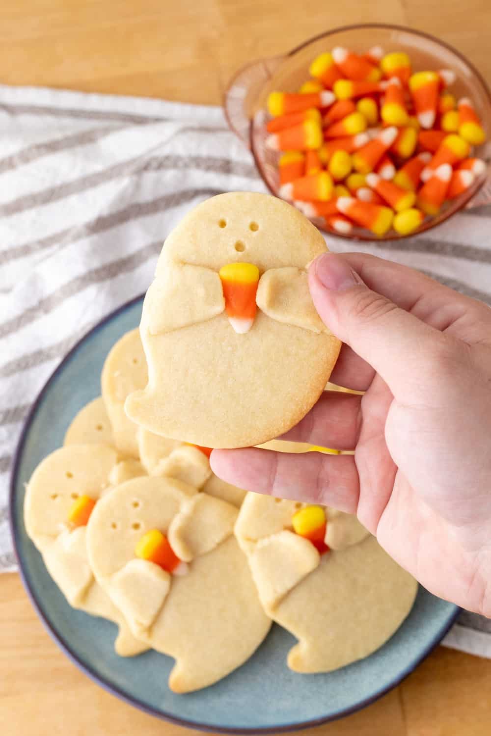 Shortbread Ghost Cookies Holding a Candy Corn
