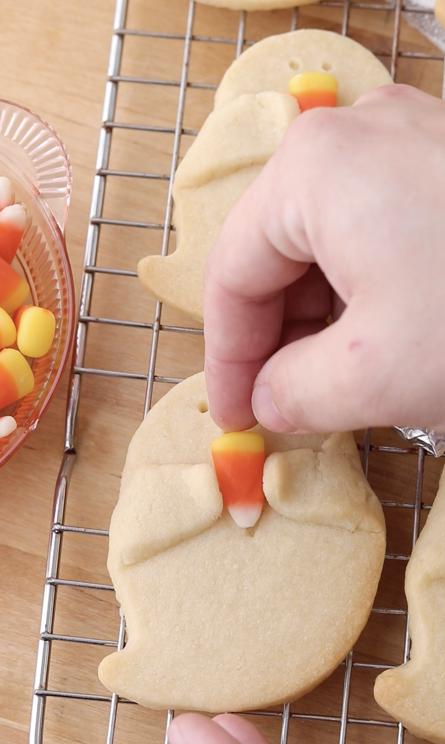 adding candy corn to ghost cookies